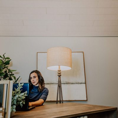 image2 A woman typing on a laptop in her home office.