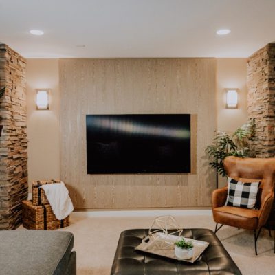 Print Media room with an acoustic wood wall, television, and a leather chair.